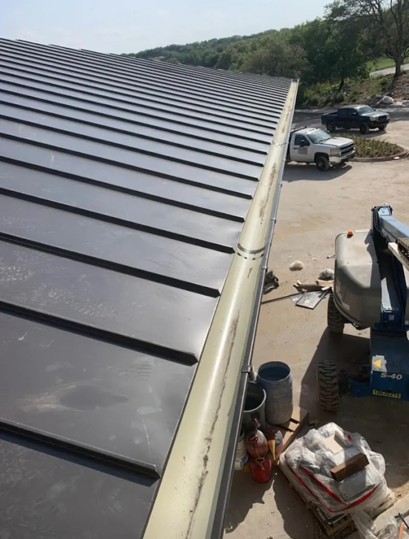 Standing seam panel and gutter detail on a metal roofing jobsite in Streetsboro